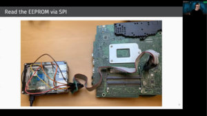 A small circuit board is connected to a larger circuit board via cabling