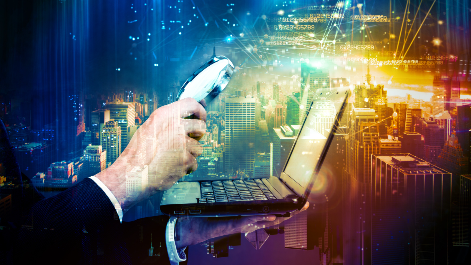 A white businessman's hand holds a magnifying glass over a lpatop as digital data surrounds a cityscape