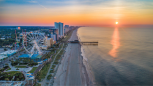 A northeastern-facing view of an urban Atlantic coastline city as the sun rises over the horizon